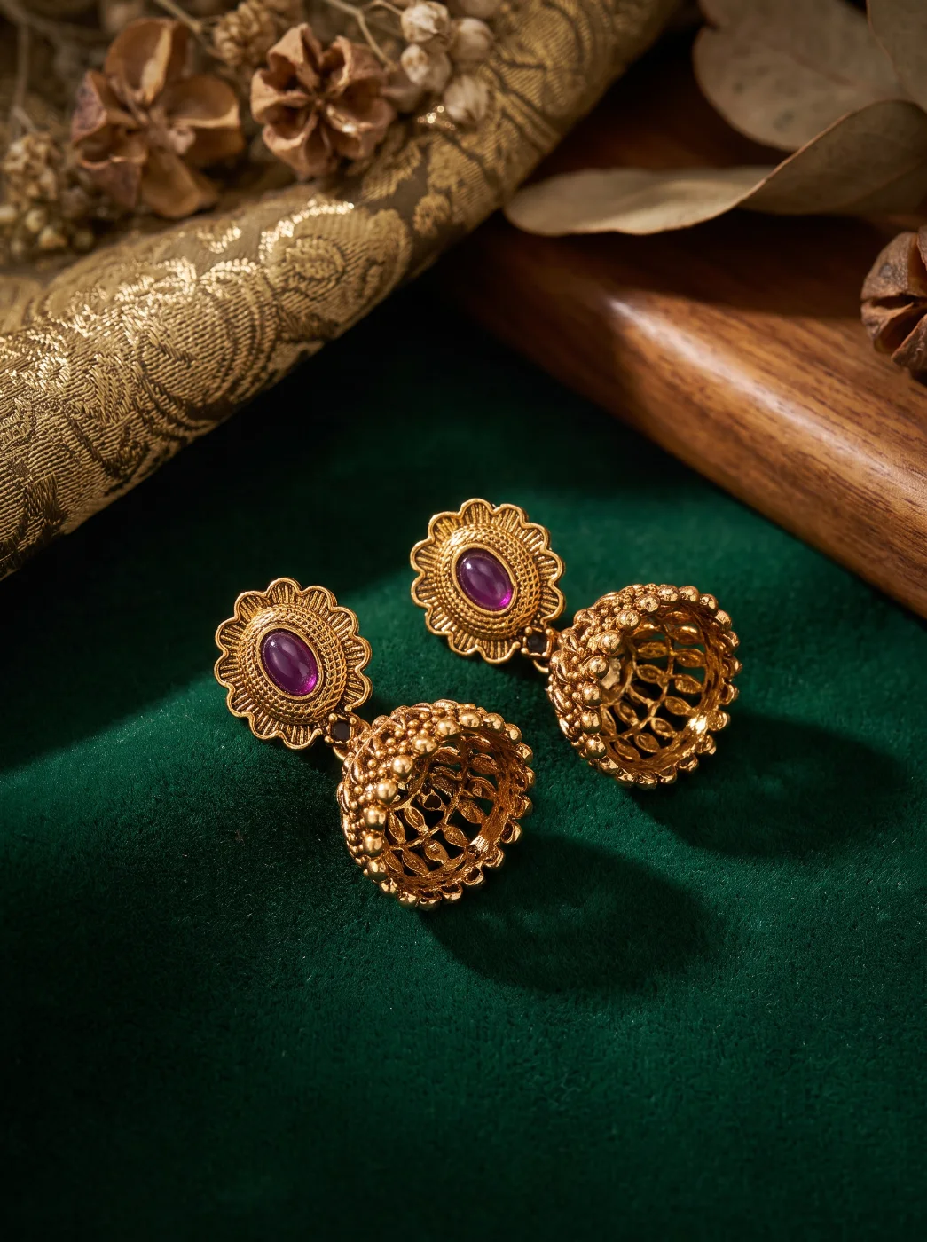 Gold Toned Traditional Jhumka Earrings with Purple Stone