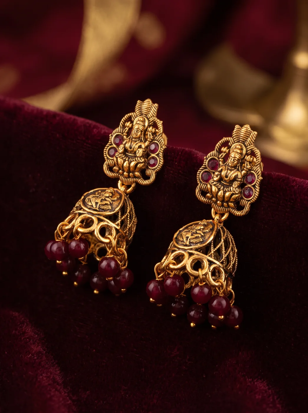Traditional Gold Toned Lakshmi Jhumka Earrings with Maroon Beads