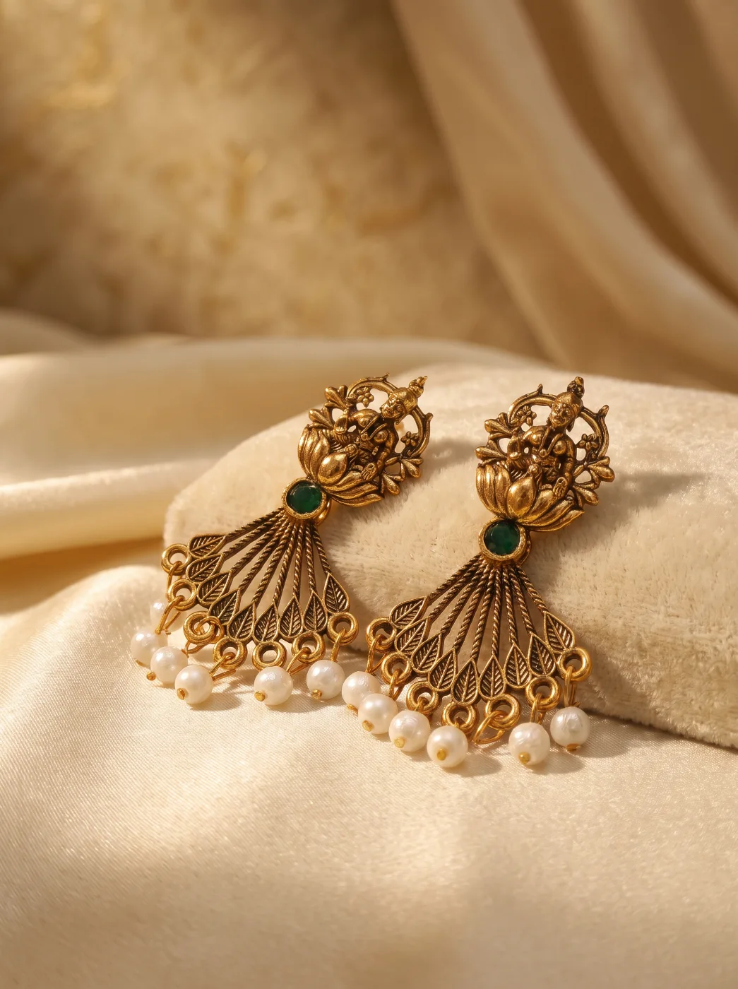 Antique Gold Toned Deity Motif Drop Earrings with Green Stone & Pearl Drops