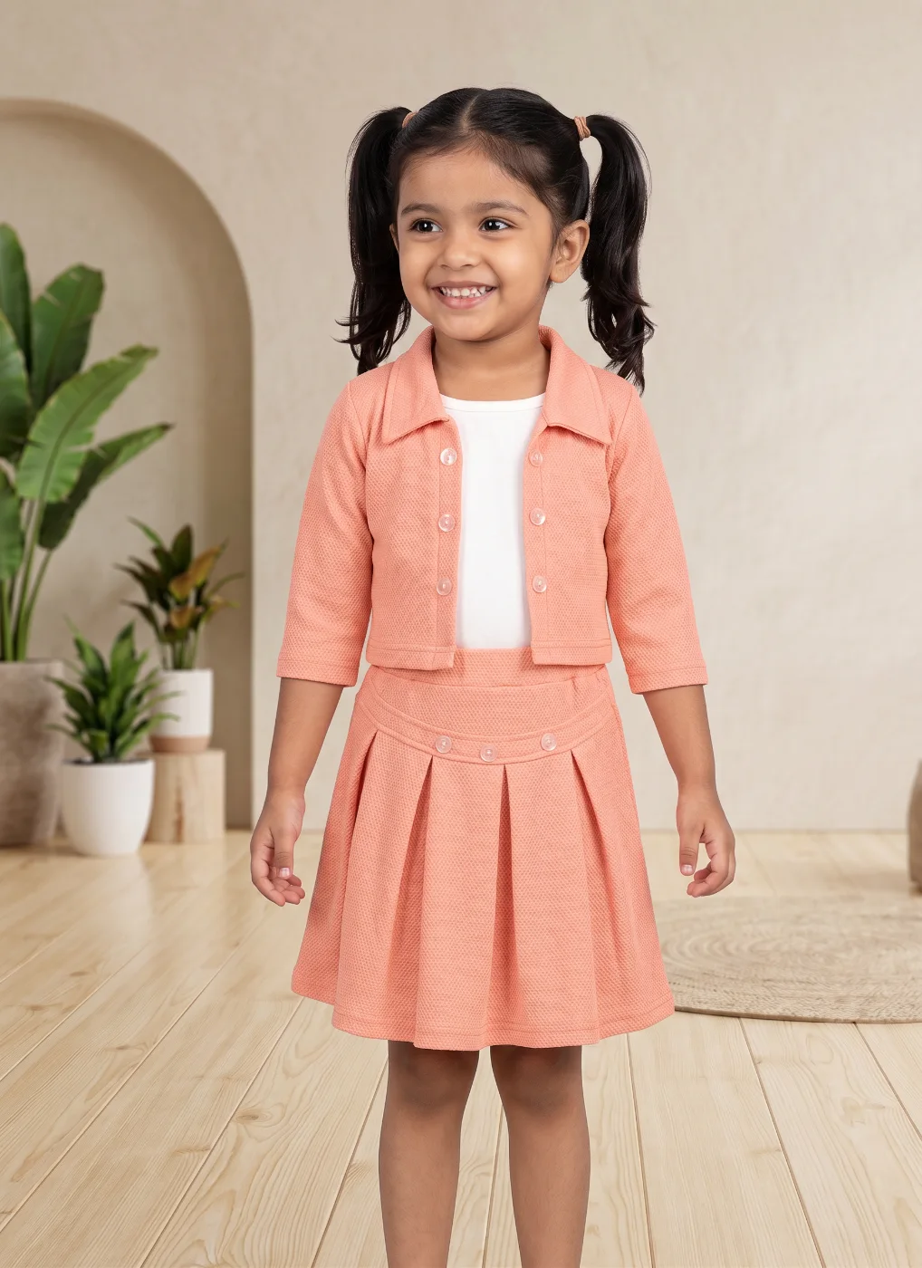 Girls Peach Textured Jacket and Pleated Skirt Co-ord Set