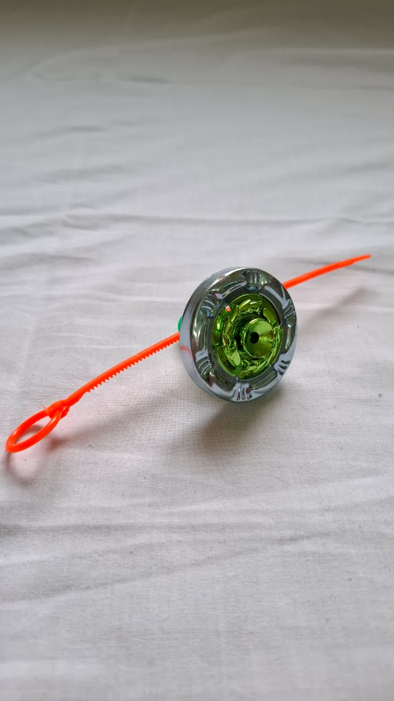 Green and Silver Spinning Top Toy with Orange Ripcord Launcher for Kids